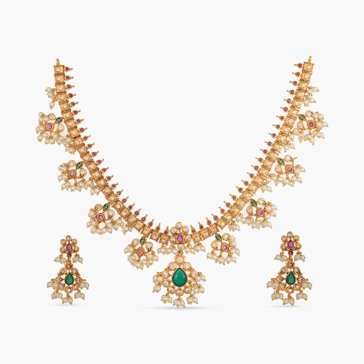 A picture of an Indian artificial jewelry set featuring a gold plated necklace and earrings embellished with pearls and green gemstones.