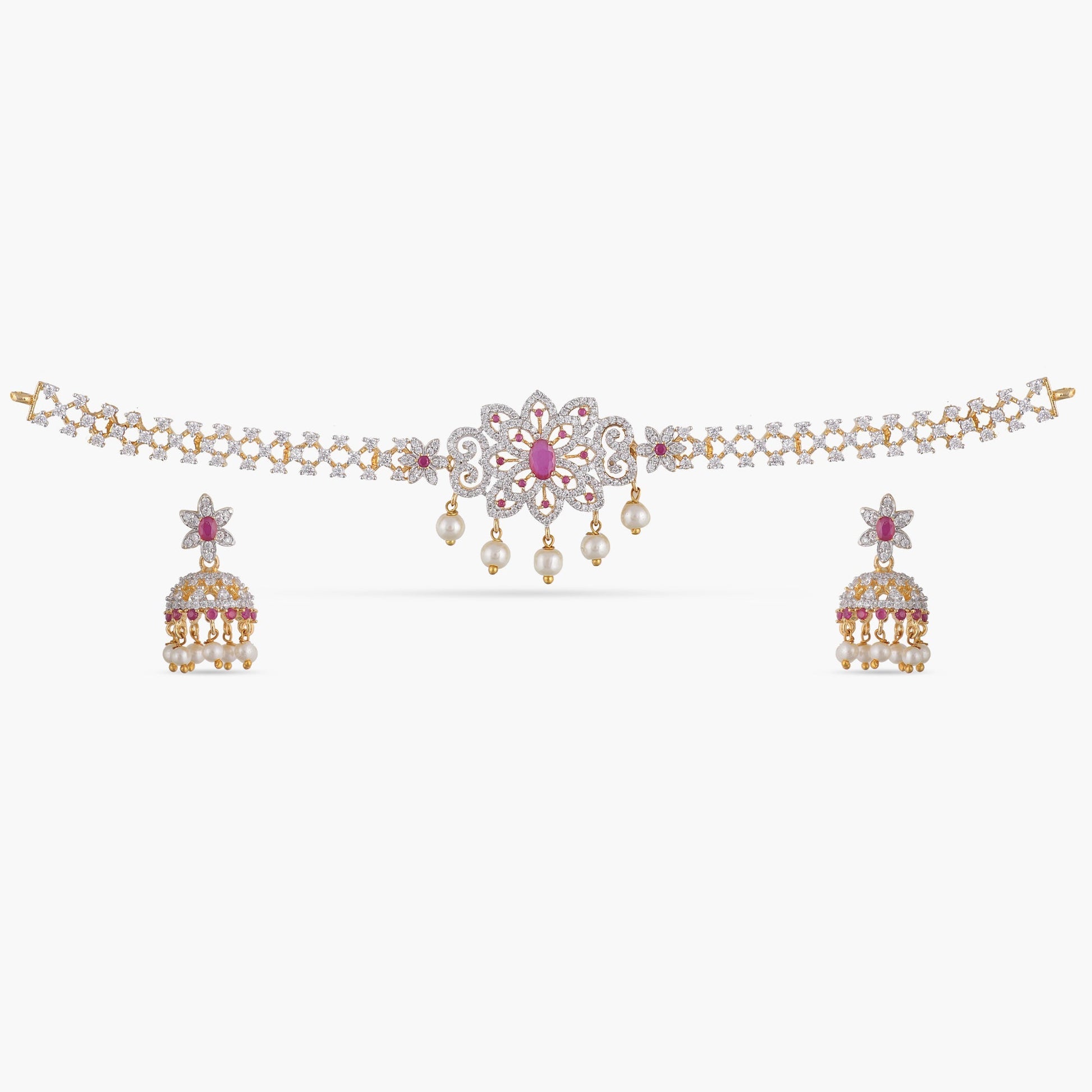 A picture of an Indian artificial jewelry set with a gold plated choker necklace and matching earrings adorned with Cubic Zirconia and red gemstones.