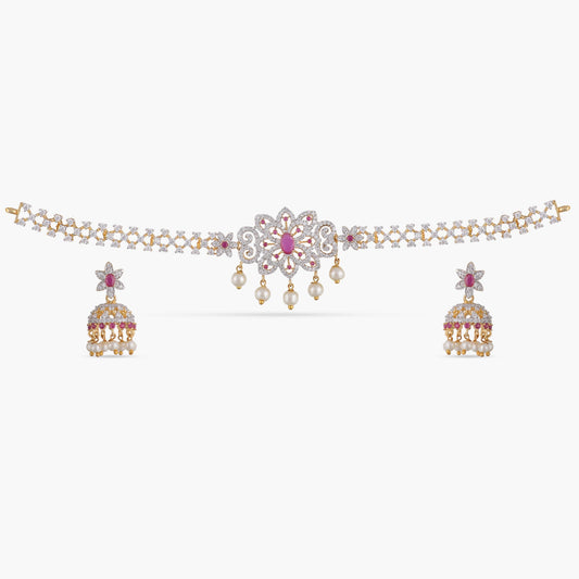 A picture of an Indian artificial jewelry set with a gold plated choker necklace and matching earrings adorned with Cubic Zirconia and red gemstones.
